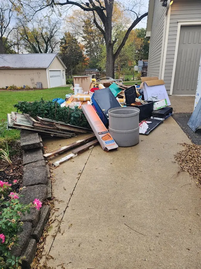 Dumpster being loaded with debris for Estate Cleanout Dumpster Rental in Stowe